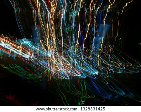 Blurred light effects. Neon glow. Night traffic. Abstract background. Colorful pattern.