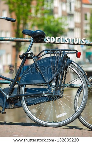 Part of dutch bike parked on a bridge in Amsterdam, Netherlands