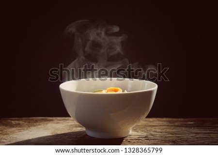 vegetables I steaming. a bowl of hot food on wood table on black background. keto concept