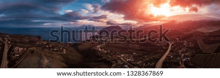 Aerial Crimean mountains landscape panorama at sunset with dramatic clouds and sea. Beautiful travel background with copy space, toned