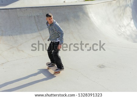 Skateboarder skateboarding on skatepark