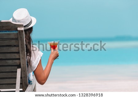 Young beautiful woman relaxing at white sand tropical beach