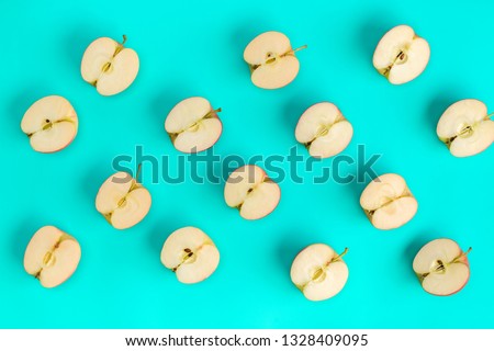 Fruit pattern of apple halves on blue background. Flat lay, top view. Food background..  Pop art design, creative summer concept.
