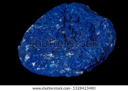 Macro mineral stone Azurite in siltstone against black background close up
