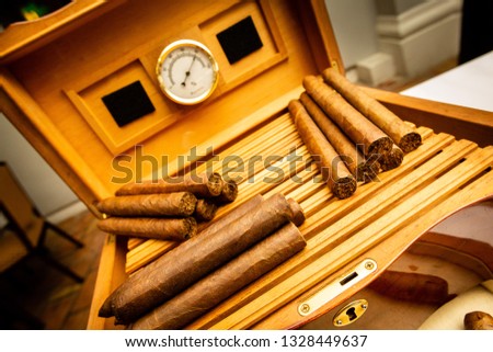 Cigars and Humidor with Cuban Smokes Rolled and Presented