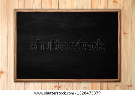 Abstract blackboard or chalkboard with frame on wooden background. empty space for add text.
