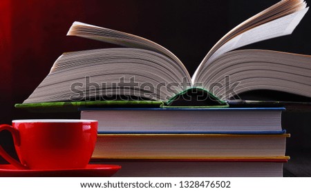 Composition with books and cup of coffee on the table.