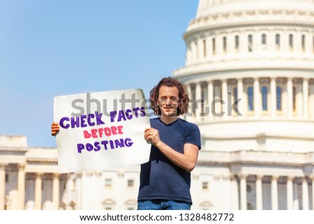 Protester holding sign check facts before posting