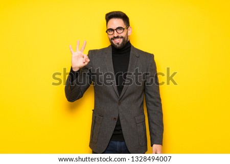 Handsome man with glasses happy and counting three with fingers