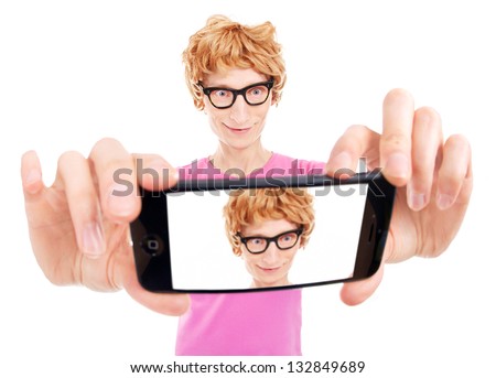 Funny nerdy guy is taking a self portrait with a smart phone