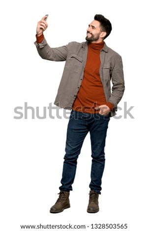 Full-length shot of Handsome man with beard making a selfie on isolated white background