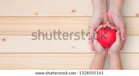 I love you Mom, Mother's Day celebration with woman parent holds young kid's hands supporting red heart gift, csr charity donation, parenting or children adoption family health nursing care concept Royalty-Free Stock Photo #1328505161
