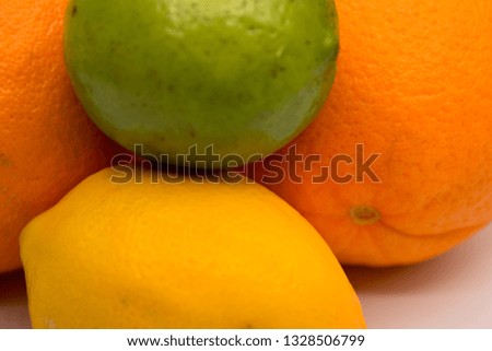 Citrus fruits including orange, lemon, and lime arranged on a seamless white background.
