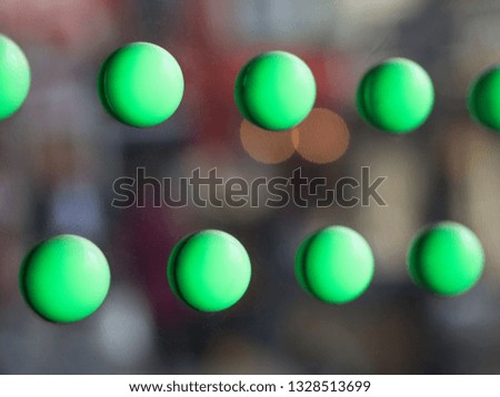 Blured green circles on a shinny sliver surface. Abstract background.