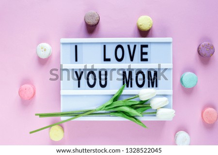 Lightbox with title I love you mom on white wooden table. Mothers day background