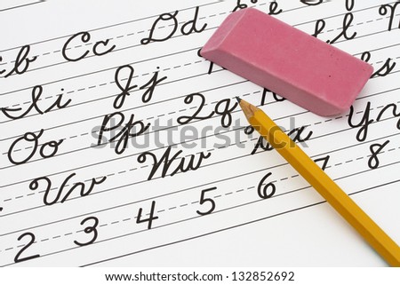 Example of cursive writing with a pencil and eraser, Learning cursive writing Royalty-Free Stock Photo #132852692