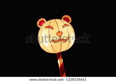 Funny cheerful smiling bear Chinese lamp striped candy. Traditional Chinese character. Chinese Lantern Festival is a funny animal. Decoration in the park for the Chinese New Year