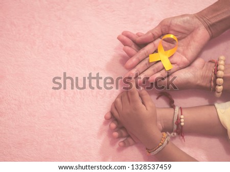 Grandma hand and grandson cancer awareness ribbon sign top view with vintage picture style.