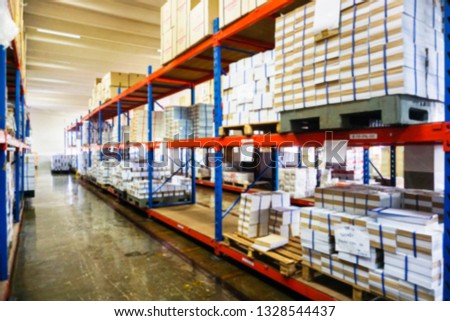 Blurry warehouse interior with shelves, boxes and document.