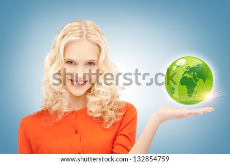 picture of woman holding green globe on her hand
