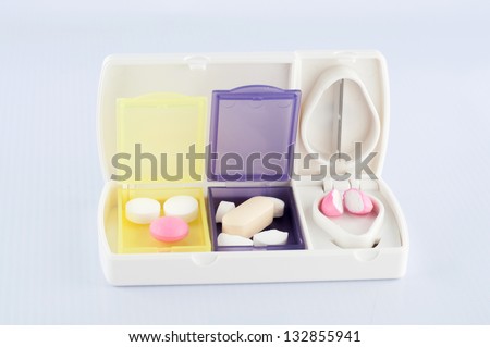 Pill box and split blade tablet show medicine concept