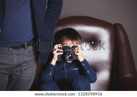 boy  with a camera. boy takes pictures