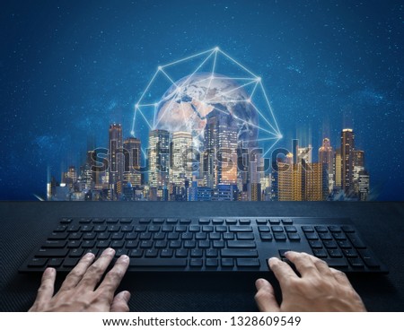 Internet, digital networking and connection. Hand typing computer keyboard and global network connection and the city. Element of this image are furnished by NASA
