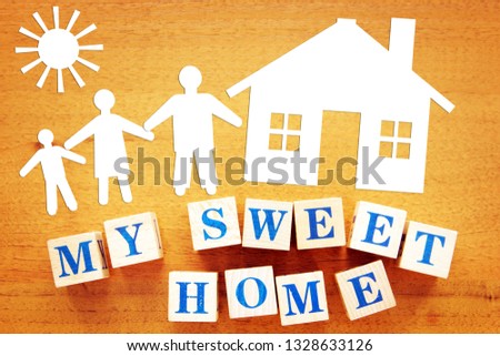 My Sweet Home. Concept of a Strong Family at Home. Paper cuttings and wooden cubes on a desk