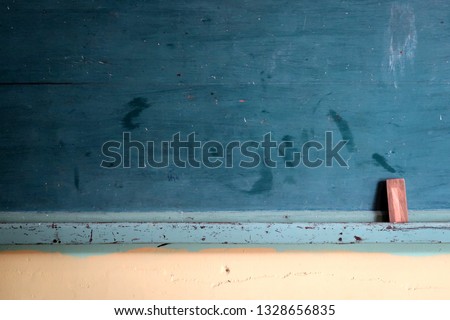 Green vintage old style retro school chalkboard / blackboard with brush -  empty blank space can be used as copy space 