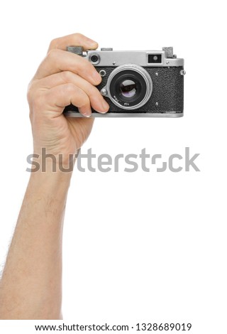 Vintage photo camera in hand isolated on white background