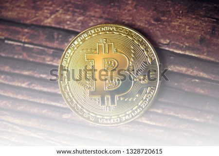 Golden Bitcoin on dark wood background  Close-up, macro shot. New Virtual Money