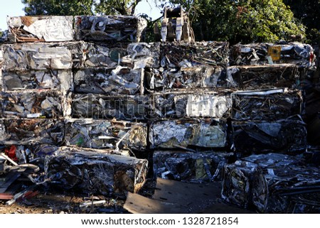 Photo of pile of pressed scrap metal at a junkyard