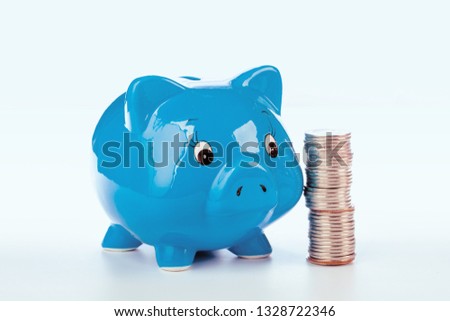 Pink piggy bank and coins isolated on white