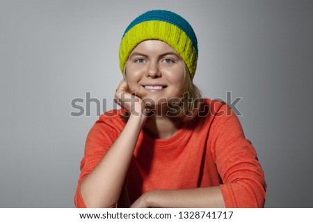 Portrait of a cheerful girl in a hat.
Girl hipster smiles.
