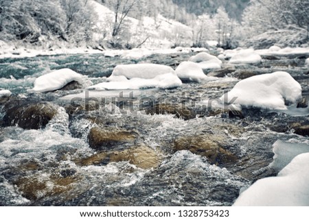 Mountain river in the canyon in the winter hike