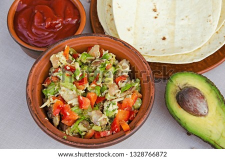 Ingredients for cooking Mexican burrito with chicken, avocado, cheese, lettuce, pepper, tomatoes, pita. A recipe for a quick and healthy lunch or picnic.