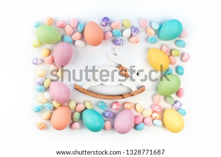 Happy Easter card. Frame with assorted sizes pastel easter eggs with vintage bunny. isolated flat lay on white background