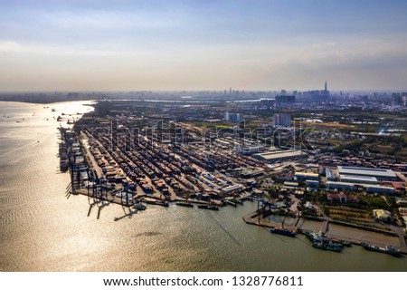 Top view aerial of Cat Lai port container, Ho Chi Minh City with development buildings, transportation, energy power infrastructure. Financial and business centers in developed Vietnam