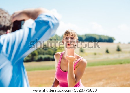 Photographer taking pictures of model during a production outdoors