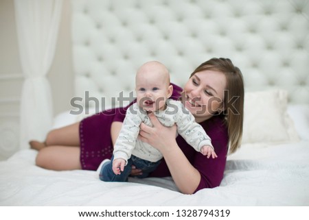 Mom with her little son on the bed.Mother and baby