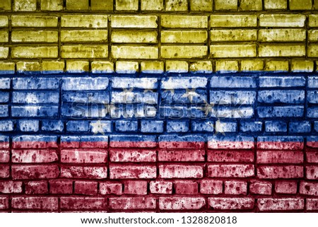 National flag of Venezuela on a brick background. Concept image for Venezuela: language , people and culture.