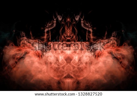 Fantasy print for clothes: t-shirts, sweatshirts.  Colorful blue and red smoke in the form of a skull, monster, dragon on a black isolated background. Background from the smoke of vape
