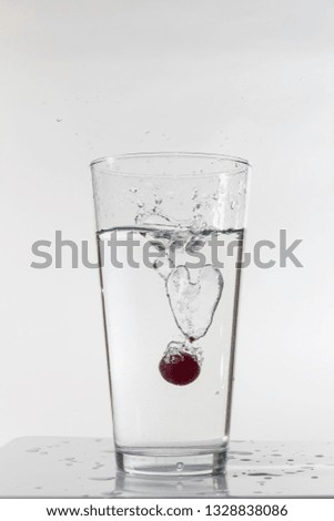 grape submerged in a glass of water.