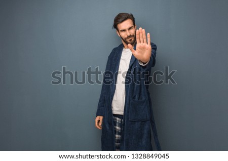 Man wearing pajama putting hand in front