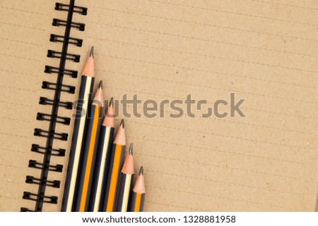 Blank sheet of notepad with pencils. View from above. Place for text