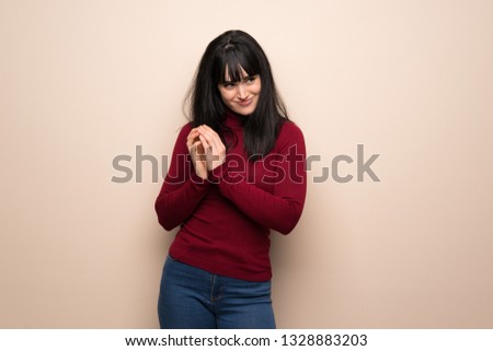 Young woman with red turtleneck scheming something