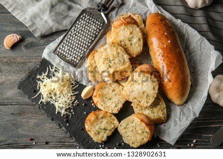 Tasty garlic bread on table