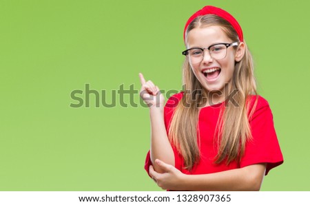 Young beautiful girl wearing glasses over isolated background with a big smile on face, pointing with hand and finger to the side looking at the camera.