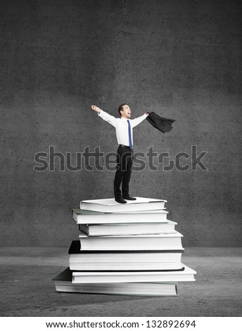 happiness businessman standing on books