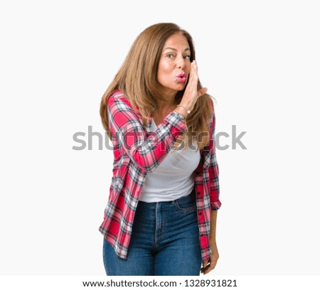 Beautiful middle age woman wearing over isolated background hand on mouth telling secret rumor, whispering malicious talk conversation